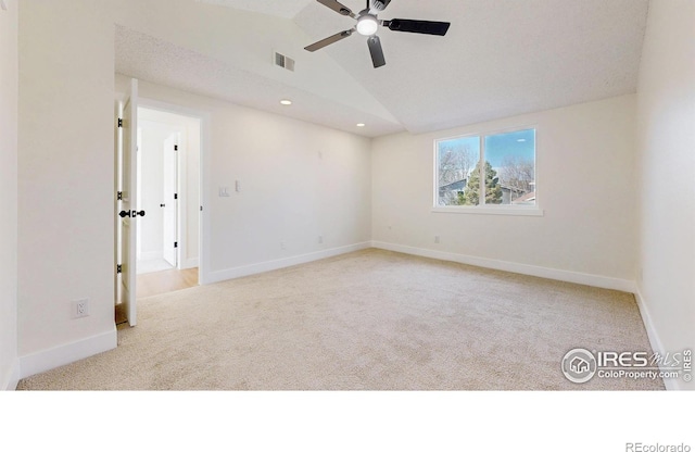 carpeted spare room with baseboards, vaulted ceiling, recessed lighting, visible vents, and ceiling fan