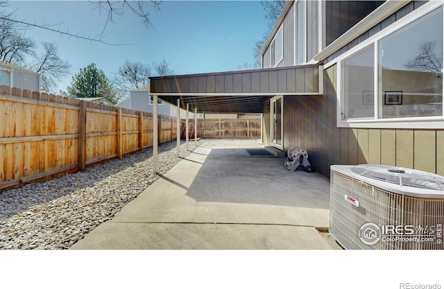 view of patio with a fenced backyard and central air condition unit