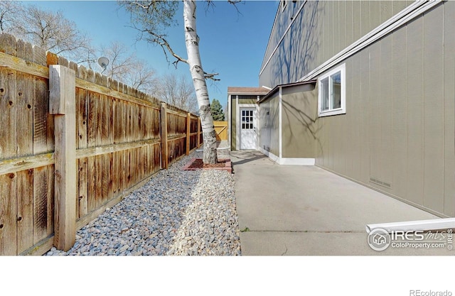 view of yard with fence and a patio