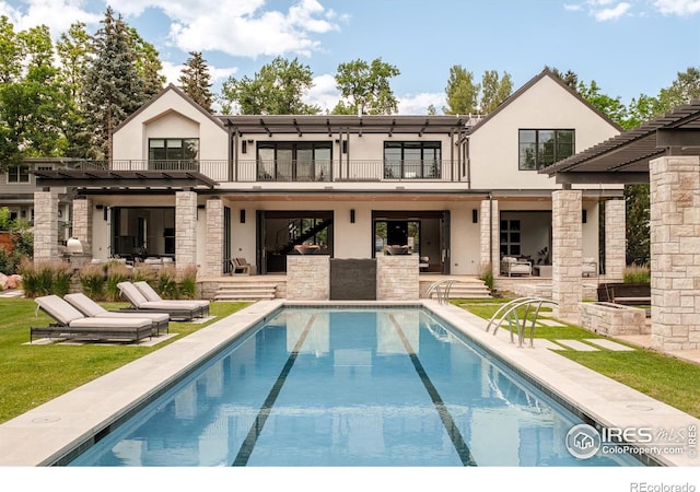 706 Juniper Ave, Boulder, CO 80304 - back of house with a balcony, a patio area, stucco siding, and an outdoor pool