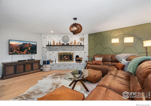 253 Courtney Dr, Loveland, CO 80537 - living area featuring a fireplace, an accent wall, and wood finished floors