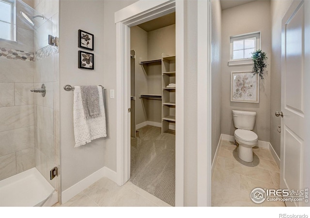 4284 Trapper Lake Dr, Loveland, CO 80538 - bathroom featuring a spacious closet, toilet, a shower stall, and tile patterned floors