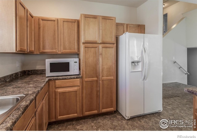 2113 Day Spring Dr, Windsor, CO 80550 - kitchen with white appliances, dark countertops, a sink, and brown cabinets