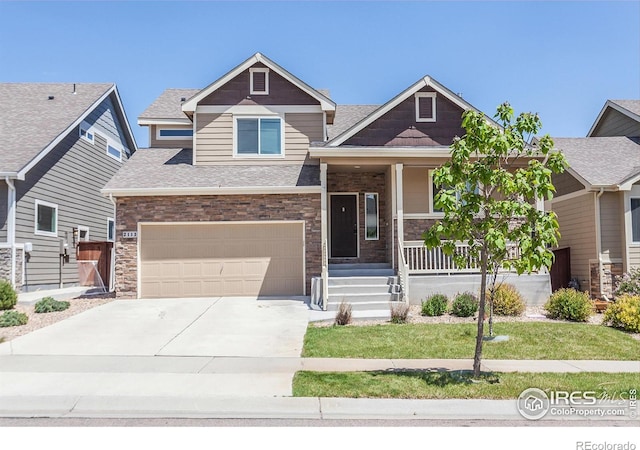 2113 Day Spring Dr, Windsor, CO 80550 - craftsman house featuring covered porch, driveway, an attached garage, and roof with shingles