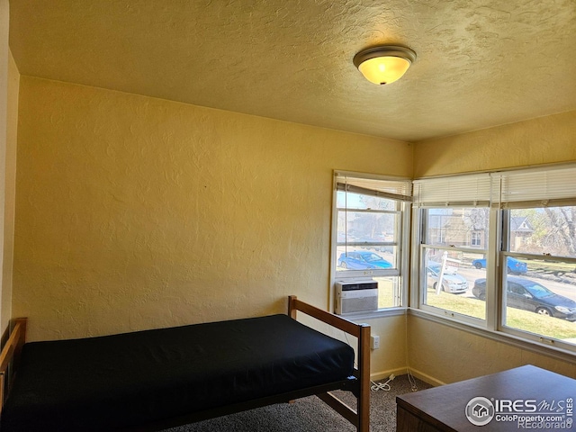 2211 10th Ave, Greeley, CO 80631 - unfurnished bedroom with cooling unit, a textured ceiling, a textured wall, and carpet floors