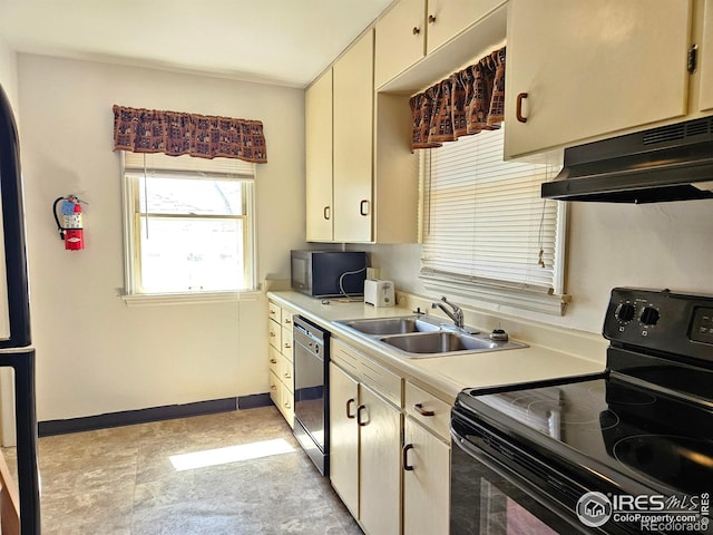 2211 10th Ave, Greeley, CO 80631 - kitchen featuring baseboards, light countertops, under cabinet range hood, stainless steel appliances, and a sink