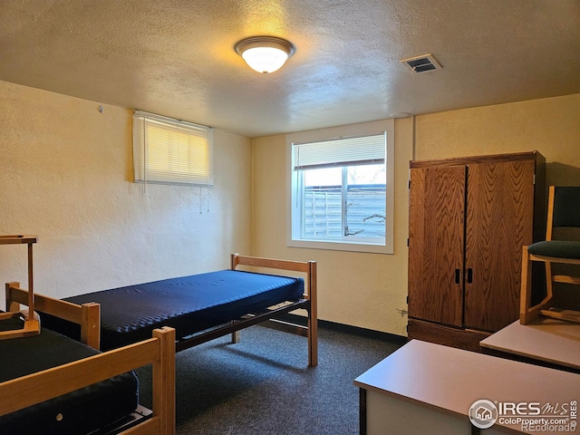 2211 10th Ave, Greeley, CO 80631 - bedroom featuring a textured wall, visible vents, a textured ceiling, and baseboards