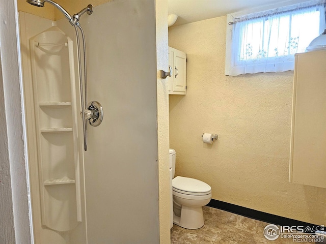 2211 10th Ave, Greeley, CO 80631 - bathroom with toilet, walk in shower, and a textured wall