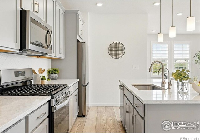 1365 Shale Dr, Erie, CO 80516 - kitchen with stainless steel appliances, light wood-style flooring, gray cabinetry, recessed lighting, and pendant lighting