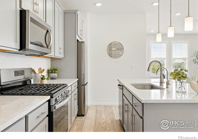 1365 Shale Dr, Erie, CO 80516 - kitchen with stainless steel appliances, light wood-style flooring, gray cabinetry, recessed lighting, and pendant lighting