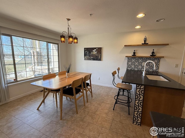 585 Callisto Dr, Loveland, CO 80537 - dining area featuring baseboards, recessed lighting, and a notable chandelier
