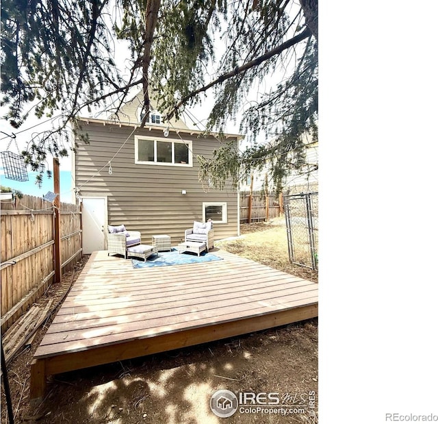 430 S 4th St, Victor, CO 80860 - back of property with a fenced backyard, a deck, and an outdoor living space