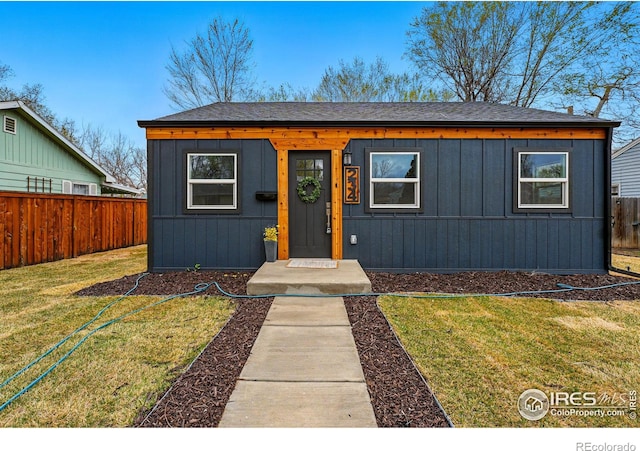 234 Lyons St, Fort Collins, CO 80521 - view of front of house with a shingled roof, fence, and a front lawn