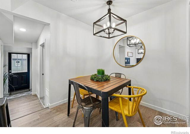 234 Lyons St, Fort Collins, CO 80521 - dining area featuring a chandelier, light wood-style flooring, and baseboards