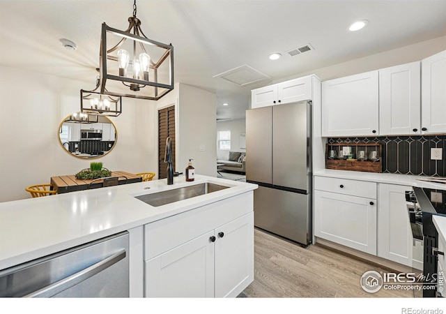 234 Lyons St, Fort Collins, CO 80521 - kitchen with a sink, light countertops, white cabinetry, stainless steel appliances, and decorative backsplash
