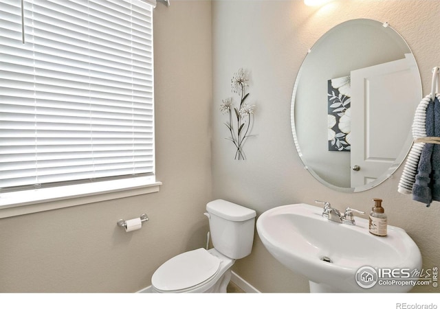 half bath featuring a sink and toilet