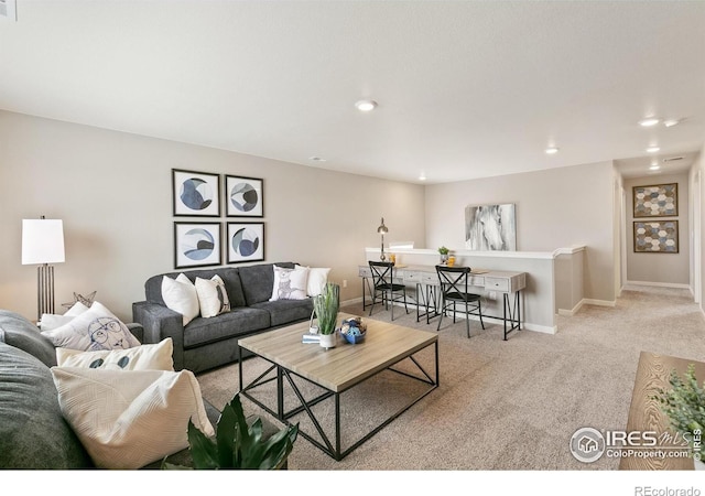 living area featuring light carpet, baseboards, and recessed lighting