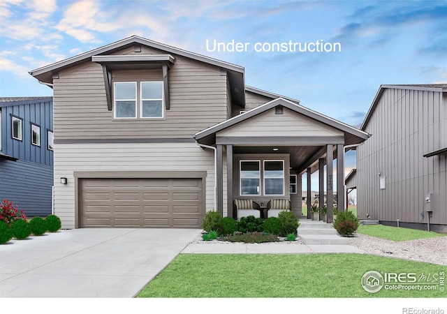 view of front of house with a front lawn, a garage, concrete driveway, and covered porch