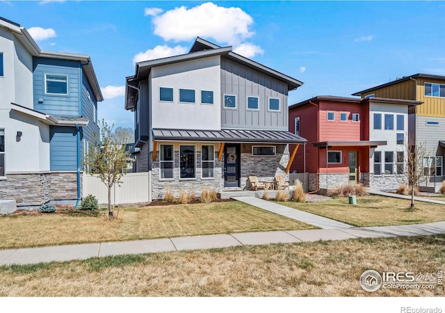 381 Pilsner St, Fort Collins, CO 80524 - view of front of property with a front yard, a porch, stone siding, and board and batten siding