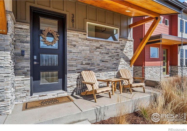381 Pilsner St, Fort Collins, CO 80524 - doorway to property with a porch, board and batten siding, and stone siding