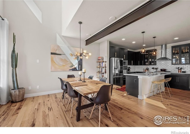 381 Pilsner St, Fort Collins, CO 80524 - dining room featuring light wood-style floors, recessed lighting, a notable chandelier, and baseboards