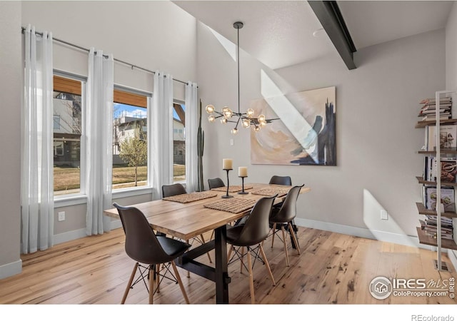 381 Pilsner St, Fort Collins, CO 80524 - dining area featuring light wood-type flooring, an inviting chandelier, baseboards, and beam ceiling