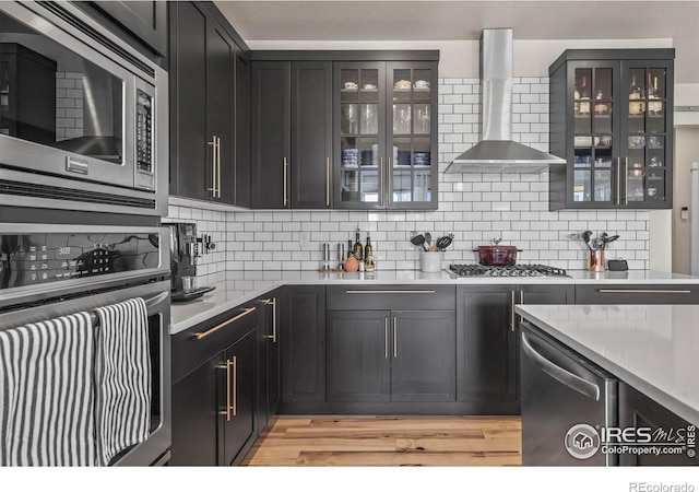 381 Pilsner St, Fort Collins, CO 80524 - kitchen with backsplash, light countertops, wall chimney exhaust hood, and stainless steel appliances