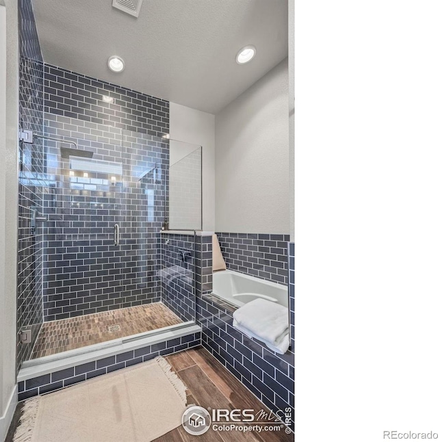 381 Pilsner St, Fort Collins, CO 80524 - bathroom featuring recessed lighting, a stall shower, wood finished floors, and a garden tub