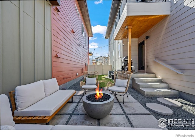 381 Pilsner St, Fort Collins, CO 80524 - view of patio featuring an outdoor living space with a fire pit and fence