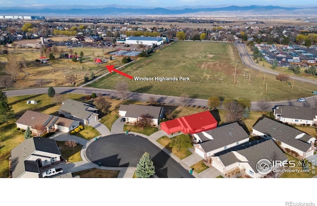 7747 Promontory Dr, Windsor, CO 80528 - aerial view of property and surrounding area with a mountainous background and nearby suburban area