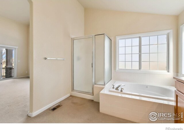 7747 Promontory Dr, Windsor, CO 80528 - full bath with plenty of natural light, a stall shower, a bath, lofted ceiling, and baseboards