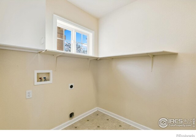 7747 Promontory Dr, Windsor, CO 80528 - clothes washing area featuring washer hookup, baseboards, electric dryer hookup, and cabinet space