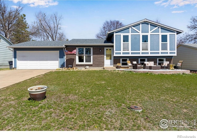 205 Lucerne Dr, Lafayette, CO 80026 - view of front of home featuring a front yard, an attached garage, an outdoor living space, brick siding, and driveway