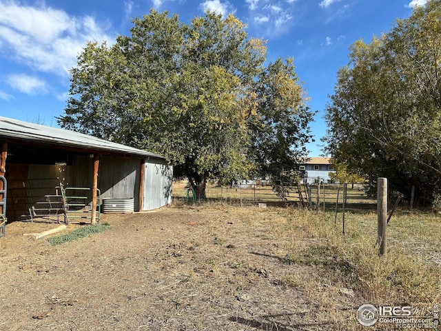 view of yard featuring an outbuilding and an exterior structure