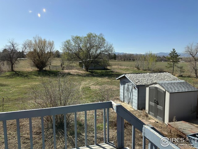 exterior space with a rural view, an outdoor structure, and a storage unit