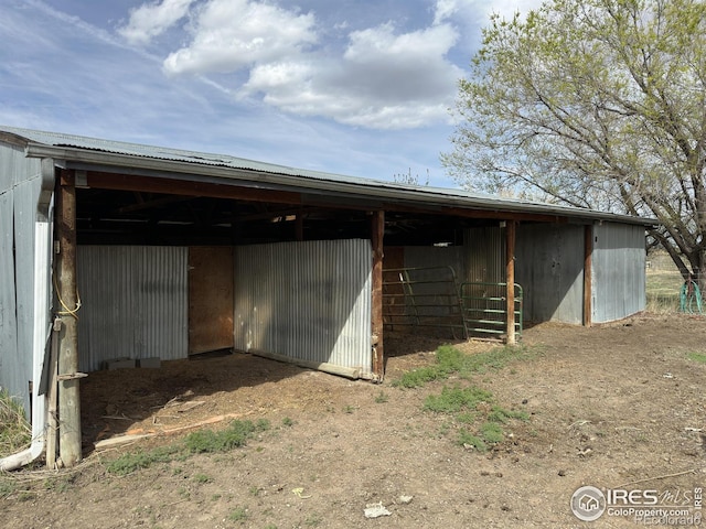 view of outbuilding with a carport, an outbuilding, and an exterior structure