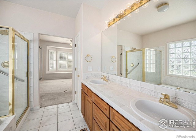full bathroom with a sink, tile patterned flooring, and a stall shower