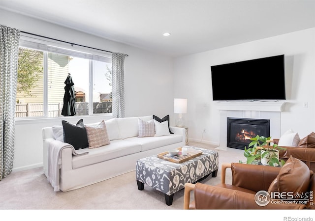 carpeted living area with a tile fireplace, baseboards, and recessed lighting