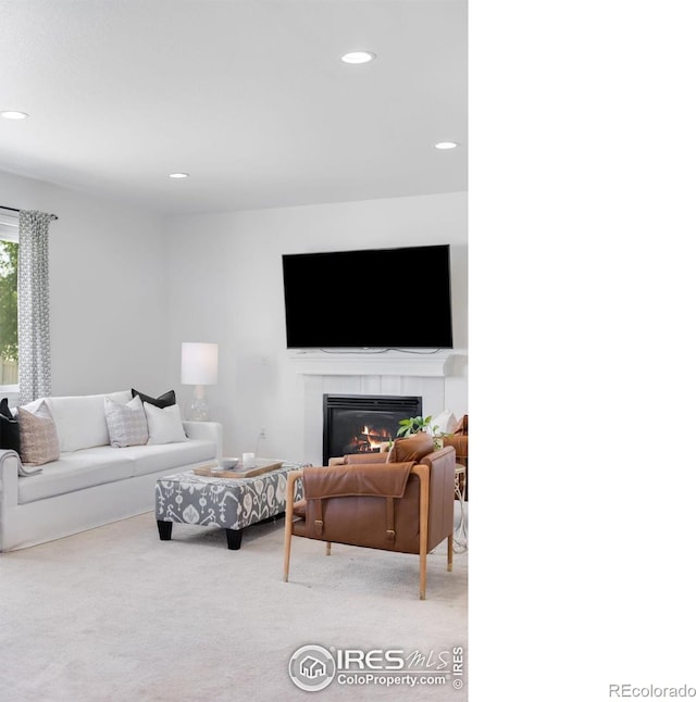 living area with a fireplace, light colored carpet, and recessed lighting