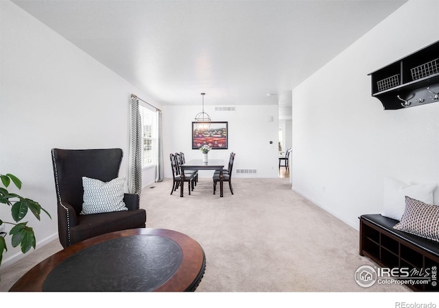 dining area featuring carpet flooring, a chandelier, and baseboards