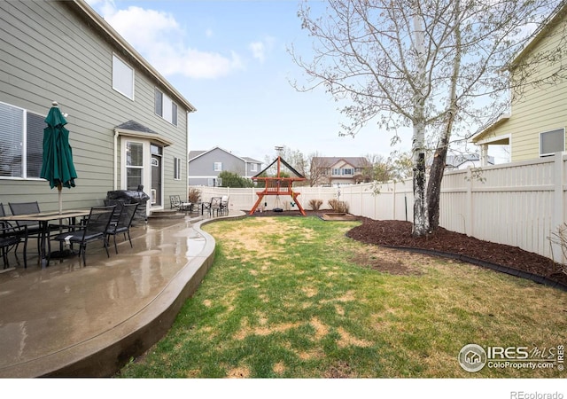 view of yard featuring a playground and a patio