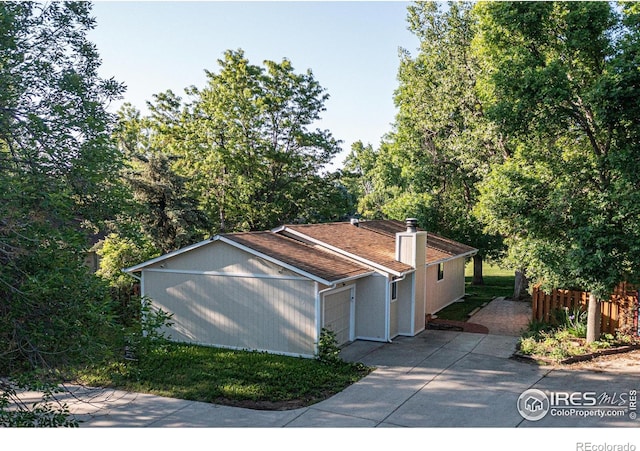 6396 Twin Lakes Rd, Boulder, CO 80301 - view of home's exterior with driveway and a chimney