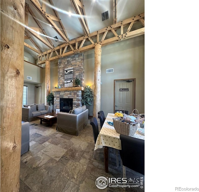 5620 Fossil Creek Pkwy Unit 4106, Fort Collins, CO 80525 - living room featuring a towering ceiling, a fireplace, and stone finish flooring