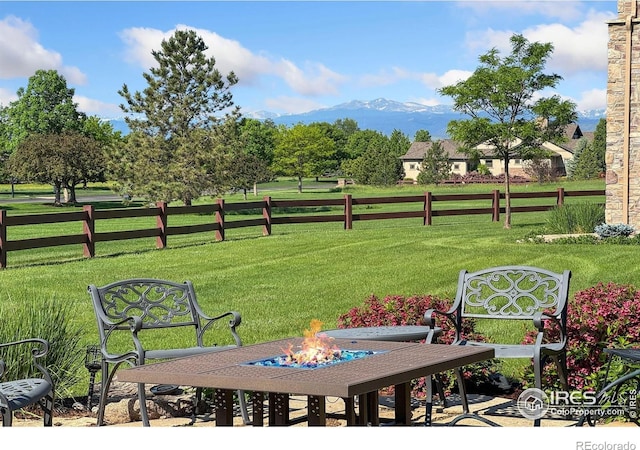 6701 Clovis Ct, Timnath, CO 80547 - view of grassy yard featuring a mountain view and a fire pit