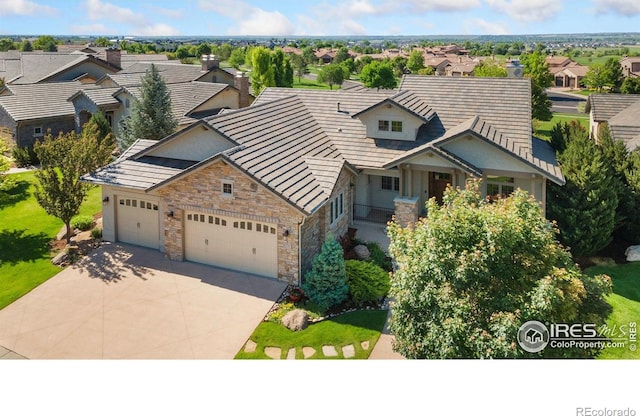 6701 Clovis Ct, Timnath, CO 80547 - view of front of property with stone siding, concrete driveway, a residential view, and an attached garage