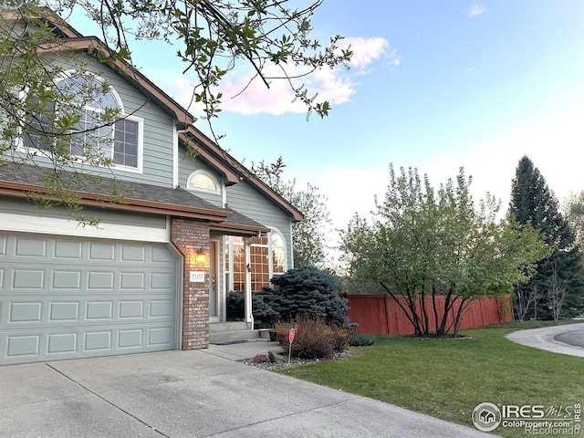 view of home's exterior with brick siding, driveway, a garage, and a shingled roof