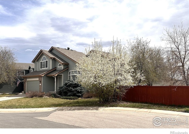 view of front of house with fence, a garage, concrete driveway, and roof with shingles