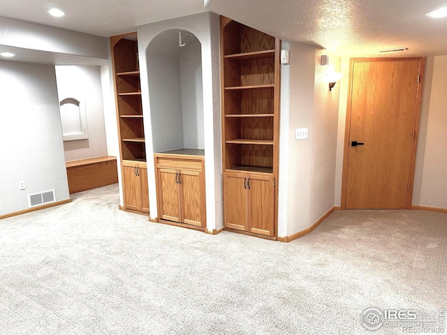 unfurnished living room with light colored carpet, baseboards, and recessed lighting