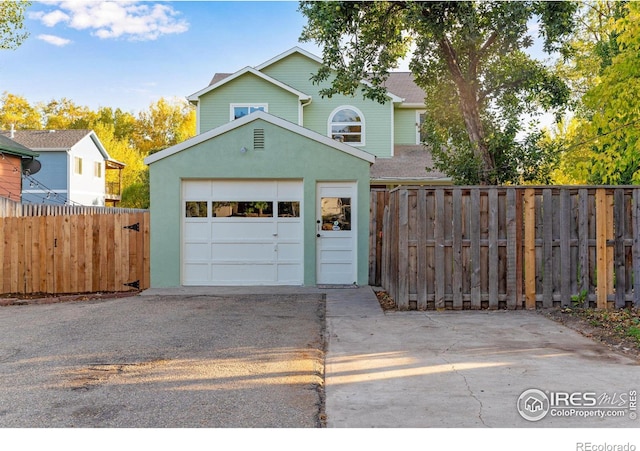 217 Park St, Lyons, CO 80540 - garage with concrete driveway and fence