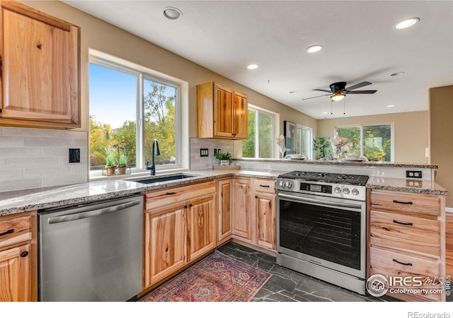 217 Park St, Lyons, CO 80540 - kitchen with appliances with stainless steel finishes, a sink, a peninsula, ceiling fan, and tasteful backsplash
